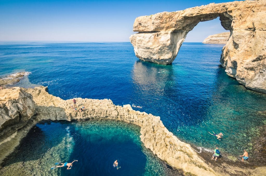 The world famous Azure Window in Gozo island - Mediterranean nature wonder in the beautiful Malta - Unrecognizable touristic scuba divers